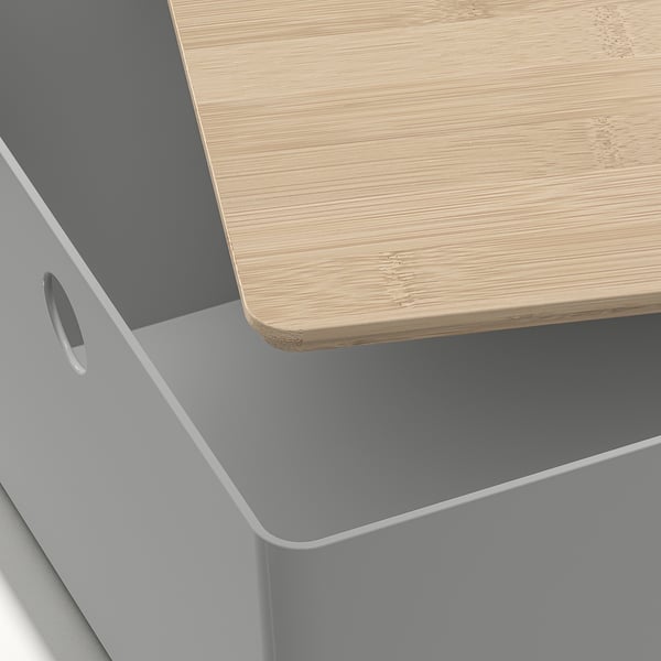 Grey plastic box with wooden top, smooth finish, and round handle.