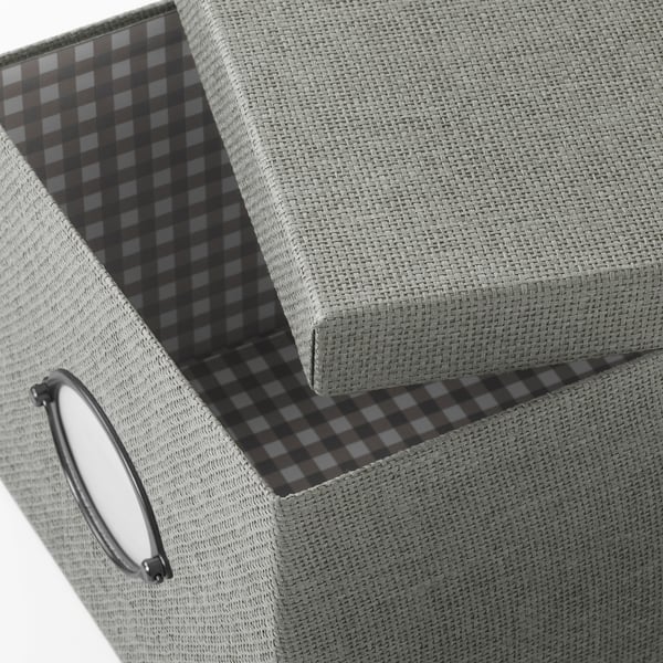 Close-up of a grey KVARNVIK storage box with a black and white chequered interior lining and a metallic handle on the side.
