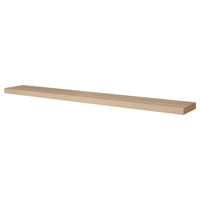 A LACK wall shelf in oak veneer. Its long, rectangular, and modern with invisible mounting brackets.