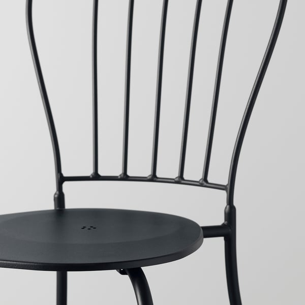 Modern black metal chair with circular seat, featuring intricate back design and sturdy construction. Ideal for outdoor use.