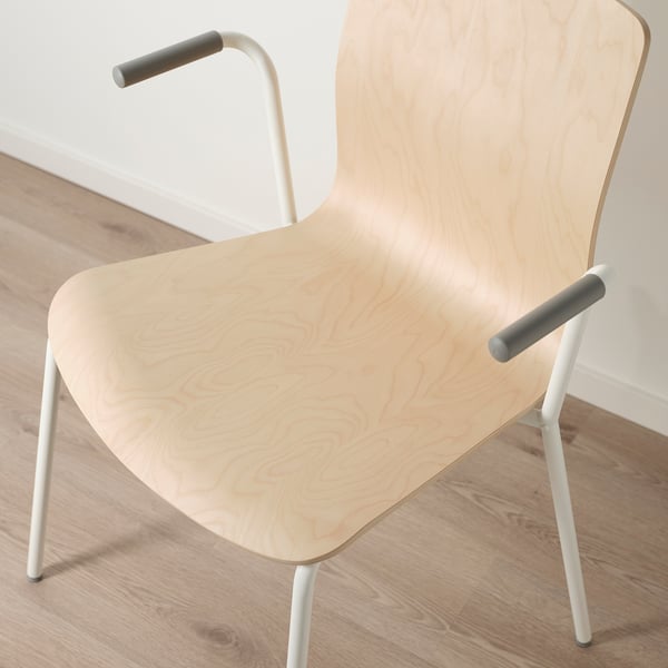 Modern scandinavian chair with natural wood seat, light metal legs, and dark armrests.