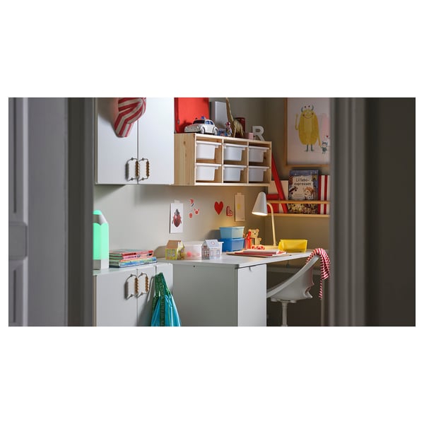 Childrens study desk is shown with multicolor accessories. Sturdy design, pull-out storage, and rounded edges for safety.