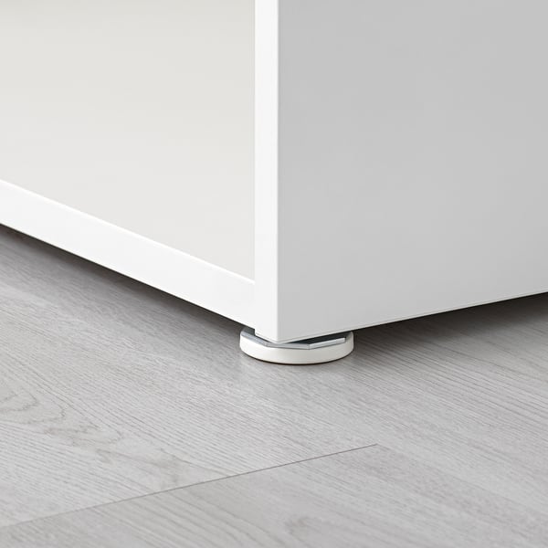 White adjustable furniture foot on grey floor.