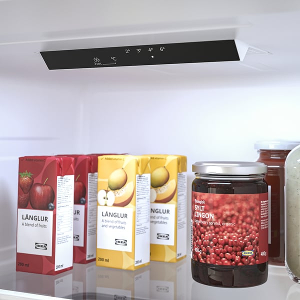 Fridge with digital temperature display and adjustable shelves, showing juice cartons and jam.