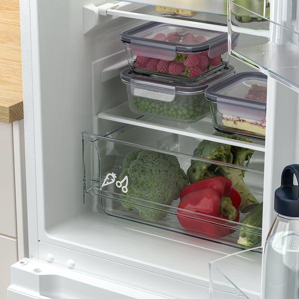 Organised fridge with adjustable shelves and veggies, led lights on.