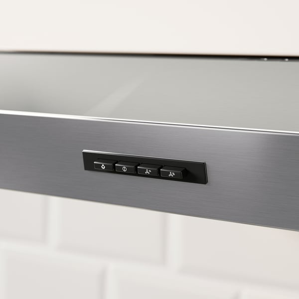 Control panel of stainless steel hood with led light switches and speed settings, shown in close-up.