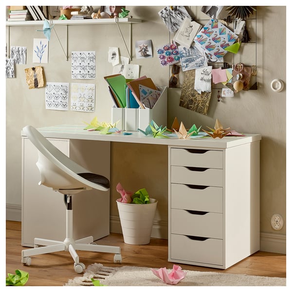Creative workspace with white LAGKAPTEN desk, five-drawer unit, office chair, and decorated wall featuring origami and art.