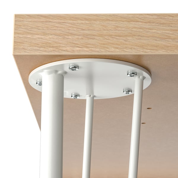 White metal legs firmly attached to a light-colored wooden table top with visible screws, ensuring stability and a neat assembly.