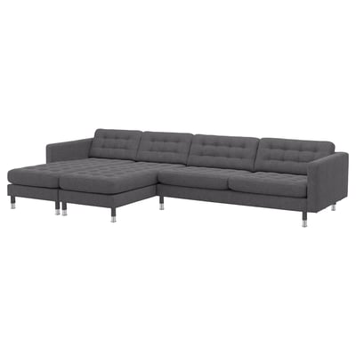 Modern dark grey l-shaped sofa with tufted cushions, chrome legs, and removable armrests.