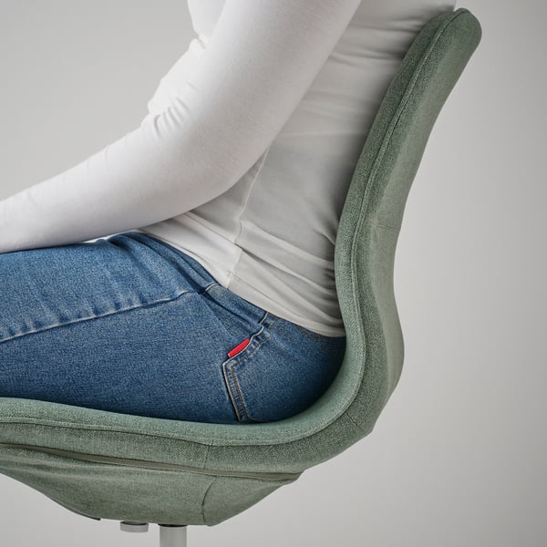 Person sitting in an adjustable office chair with lumbar support.