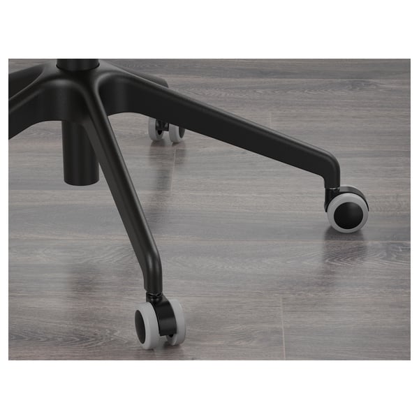 Office chair base with black wheels on wooden floor, emphasising stability and engineering precision.