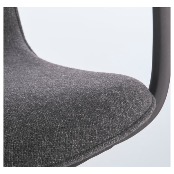 Close-up of sleek, upholstered office chair, showcasing curved design and high-quality fabric.