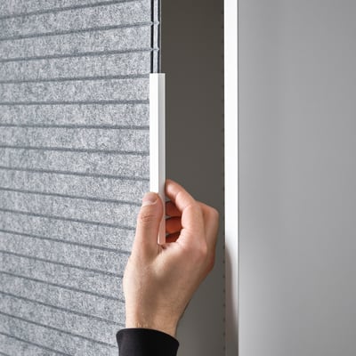 Hand adjusts handle on sliding door panel.