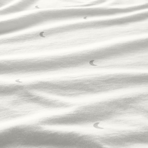 Soft, monochrome jersey fabric closeup with gentle folds, showcasing smooth texture.