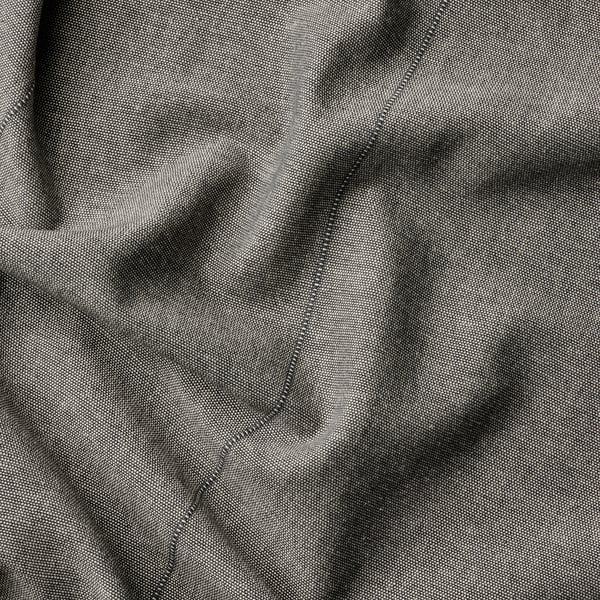 Dark grey curtain close-up, smooth weave texture, neatly stitched edges.