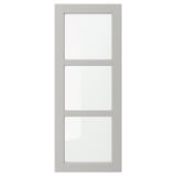 A grey LERHYTTAN cabinet door with a solid wood frame and bevelled edges, housing three clear glass panels in a rectangular layout.