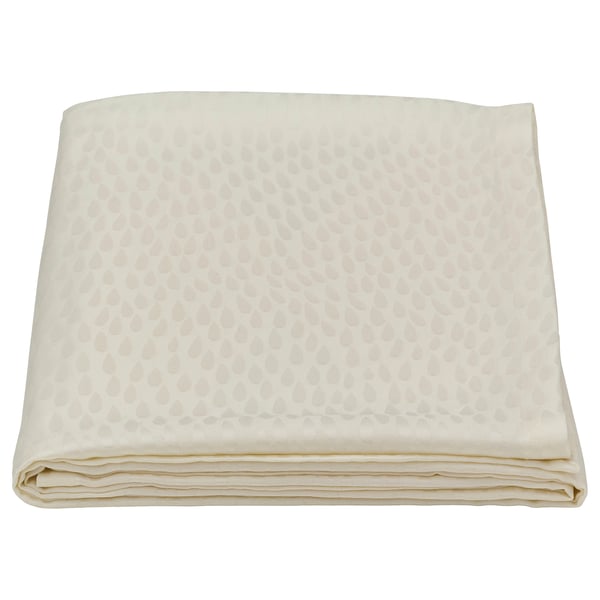 Folded cream-colored LIGUSTER tablecloth with textured pattern. Made from lyocell and viscose/rayon.