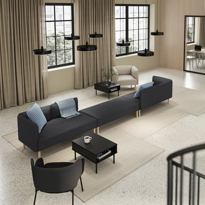 A modern living space with a LILLEHEM grey modular sofa and black coffee table, accented with blue pillows.