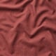 Close-up of smooth, reddish-brown fabric with subtle melange effect, showcasing its durable and soft texture.