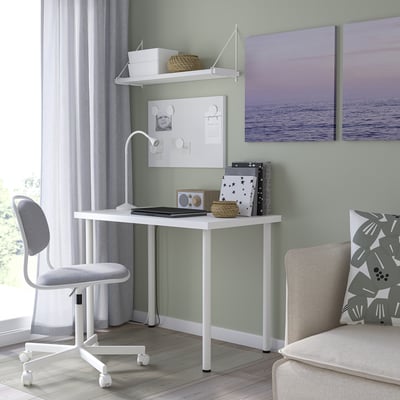 Small white l euro-style desk with chair and decor in room.