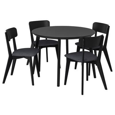 Black round dining table with four matching chairs, sleek design, hardwood materials.