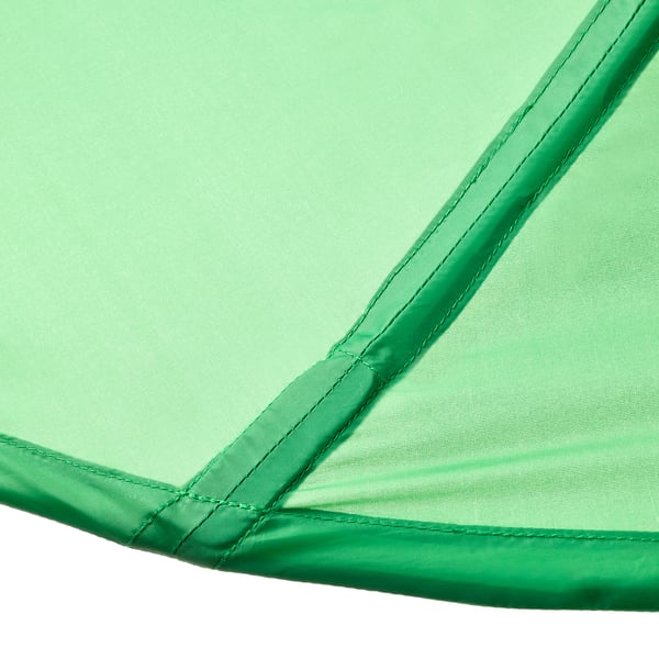 Close-up of green mesh fabric with neat stitching, showcasing high-quality craftsmanship.