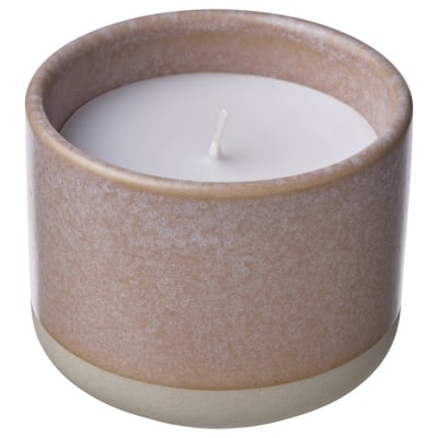 A cylindrical LUGNARE scented candle in a beige ceramic jar with a white candle core and wick.