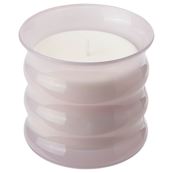Light pink LUGNARE scented candle in a glass cup with a spiral design and cotton wick.