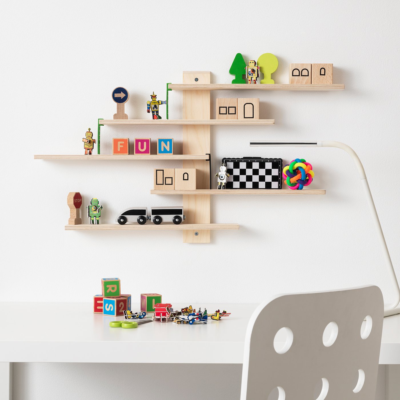 LUSTIGT wood shelf with movable shelves holding toys and items, next to a white chair.