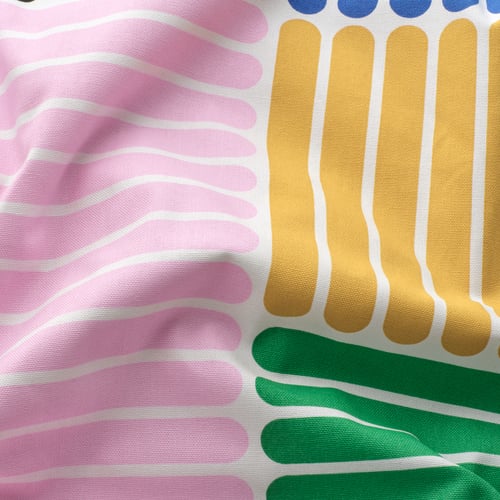 Colourful, abstract patterns on a fabric, likely a textile product, with vibrant pink, green, yellow, and blue hues.