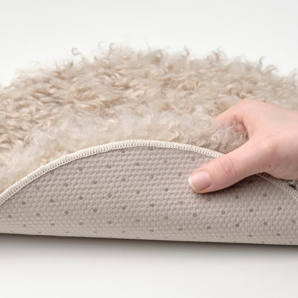 Hand feels soft, curly chair pad. Non-slip bottom keeps it steady.