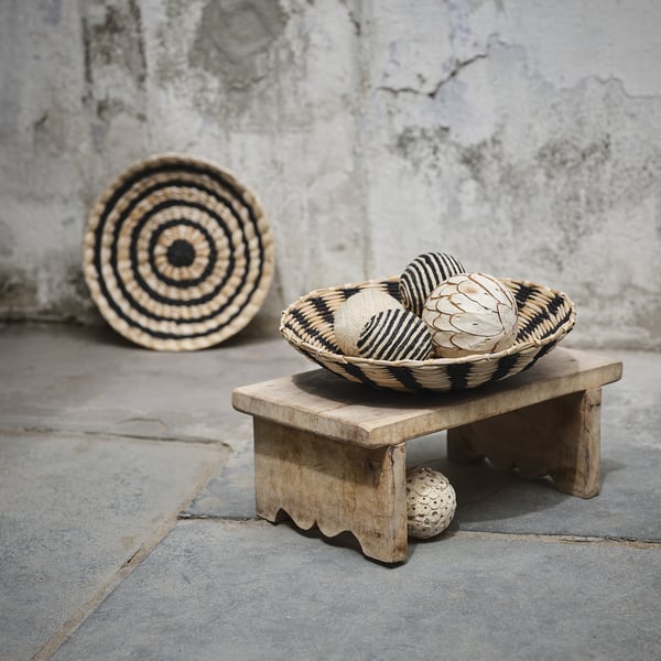 Woven basket bowl with spheres on rustic stand, showcasing handcrafted, geometric design. Ideal for wall or table decor.