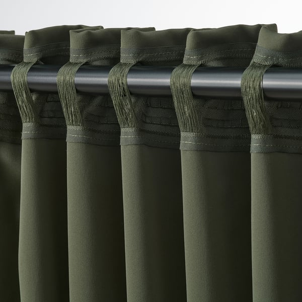 Dark green MAJGULL block-out curtains with loop tabs, offering privacy and light control.