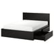 Black modern bed with clean lines, featuring a high headboard and storage drawers. Made from wood veneer and supported by a metal base.