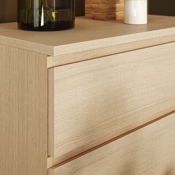 Modern wooden chest with sleek design, featuring one open drawer and clean lines.