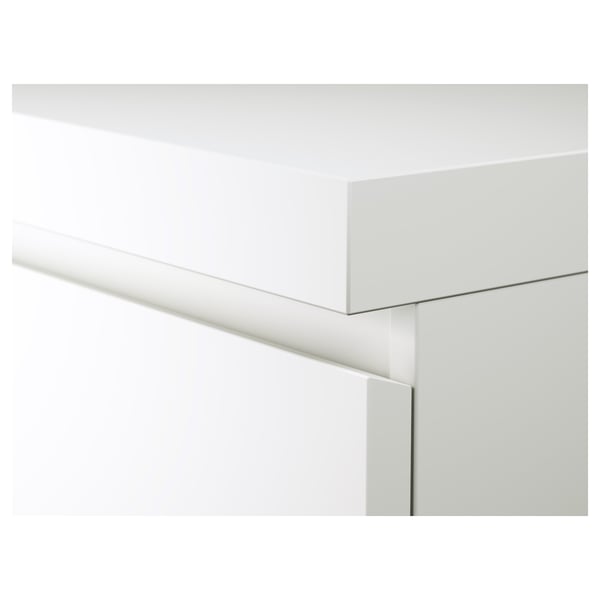 White furniture edge detail; sleek, modern design; clean finish; precision craftsmanship.