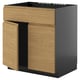 METOD kitchen unit in oak and black with minimalist design and integrated handles.