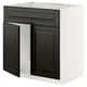 Modern black and white METOD kitchen cabinet with sleek, bevelled edges.