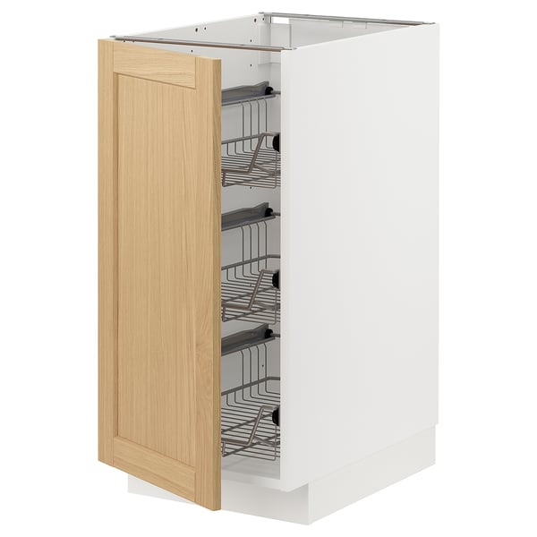 Open white kitchen cabinet with oak door and pullout shelves.