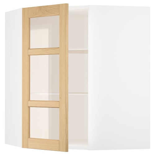A white METOD kitchen cabinet with oak trim and glass doors.