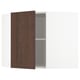 An open white corner cabinet with a dark brown wooden door and a single shelf inside.