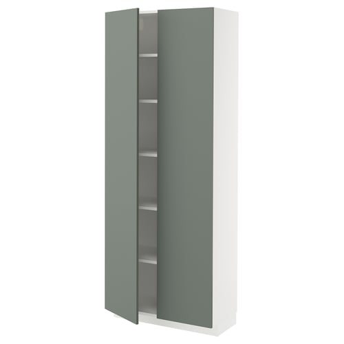 Depicts a white and green kitchen cabinet from the METOD system, featuring an adjustable shelf and a green door.