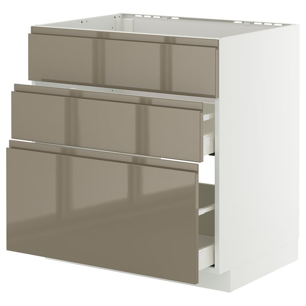 A modern, white METOD kitchen cabinet with three high-gloss, dark grey-brown drawers and sleek handles.