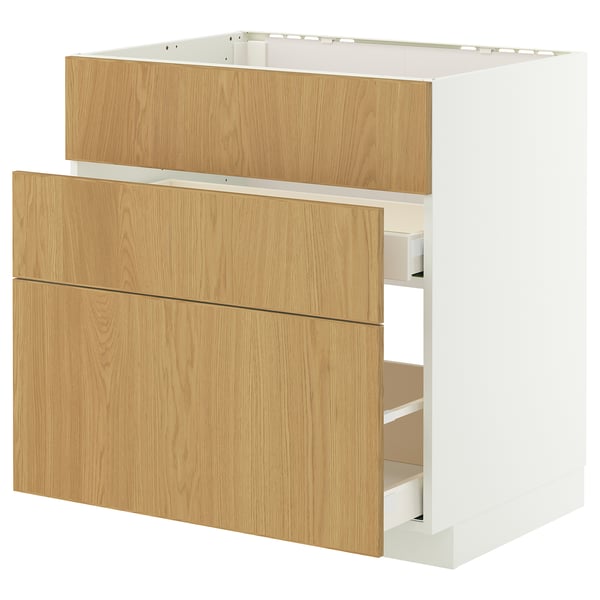 A METOD kitchen cabinet with white and light wood drawer fronts. This modern design smooth-running drawers and a sturdy frame.