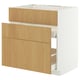 A METOD kitchen cabinet with white and light wood drawer fronts. This modern design smooth-running drawers and a sturdy frame.