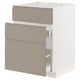 Modern beige-grey METOD kitchen cabinet with three drawers and integrated handles.