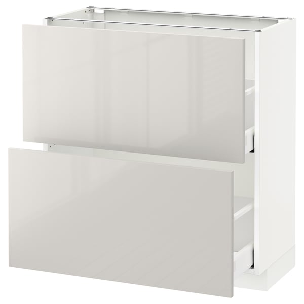 METOD high-gloss white kitchen cabinet with open drawers for storage.