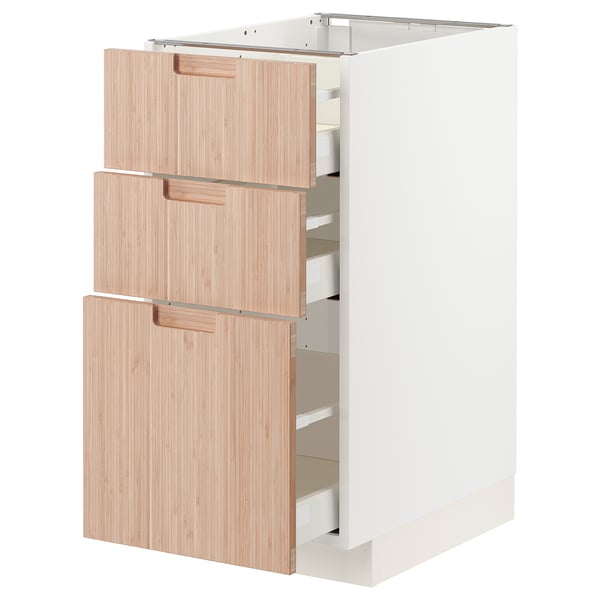 Modern kitchen cabinet with three light bamboo drawers, sleek white design.