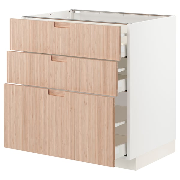 Modern kitchen storage unit, white with light bamboo drawers, three large drawers, sleek minimalist design.
