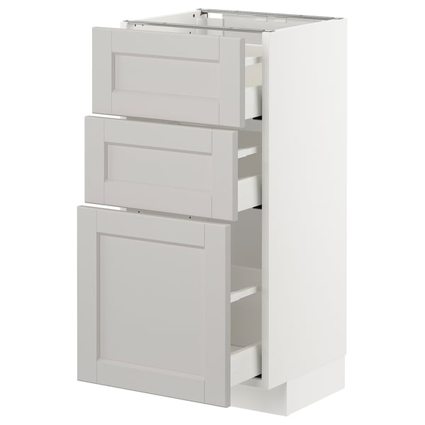White METOD kitchen unit with beveled edges and multiple drawers for storage.